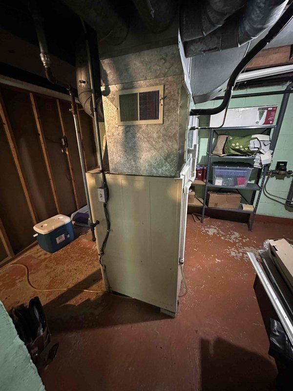 Conducted comprehensive assessment of existing HVAC system in basement utility room. Documented aging furnace/air handler unit with connected galvanized metal ductwork system. Evaluation confirmed need for full system replacement due to equipment condition and potential efficiency improvements.