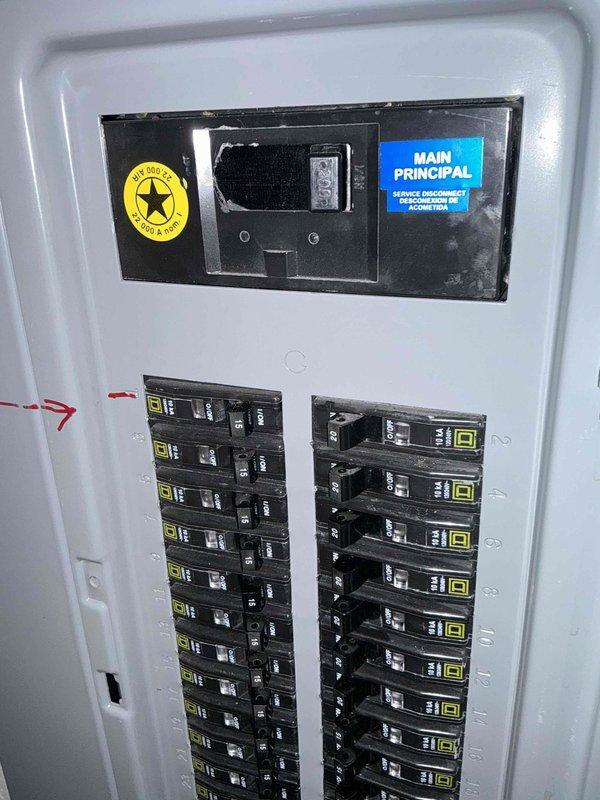 Completed site evaluation for HVAC replacement project. Inspected existing Lennox outdoor unit which showed signs of snow accumulation and potential weight stress from debris (large rock) on top cover. Examined electrical service panel to verify capacity for new system installation, noting Square D breakers in good condition with appropriate service disconnect. Documented current PVC pipe configuration and electrical junction box placement to plan proper connections for replacement unit.