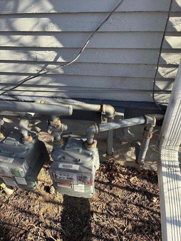 Performed diagnostic inspection on gas furnace, discovering internal component issues as evidenced by visible wear on motor assembly and electrical connections. Inspected exterior gas meter and supply lines for proper function and safety compliance. Resolved issue by cleaning debris from system components and verifying proper gas supply pressure at meter.