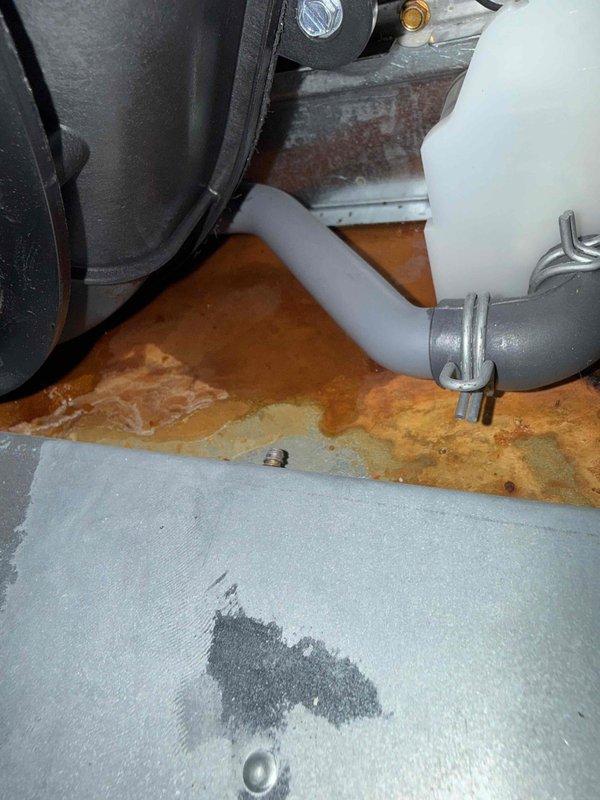 Performed routine maintenance tune-up on residential furnace system. Inspected internal components including control board, wiring connections, and PVC ventilation pipes. Identified and cleaned minor rust/water damage near condensate drain line, securing loose drain hose with new clamp to prevent future leakage issues.