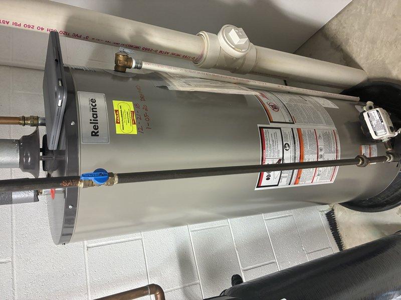 Successfully installed a Reliance tanked water heater in utility room. Connected unit to existing plumbing with copper fittings and verified proper connection to ventilation system via PVC piping. Installation completed with all required valves and safety features in place according to manufacturer specifications.