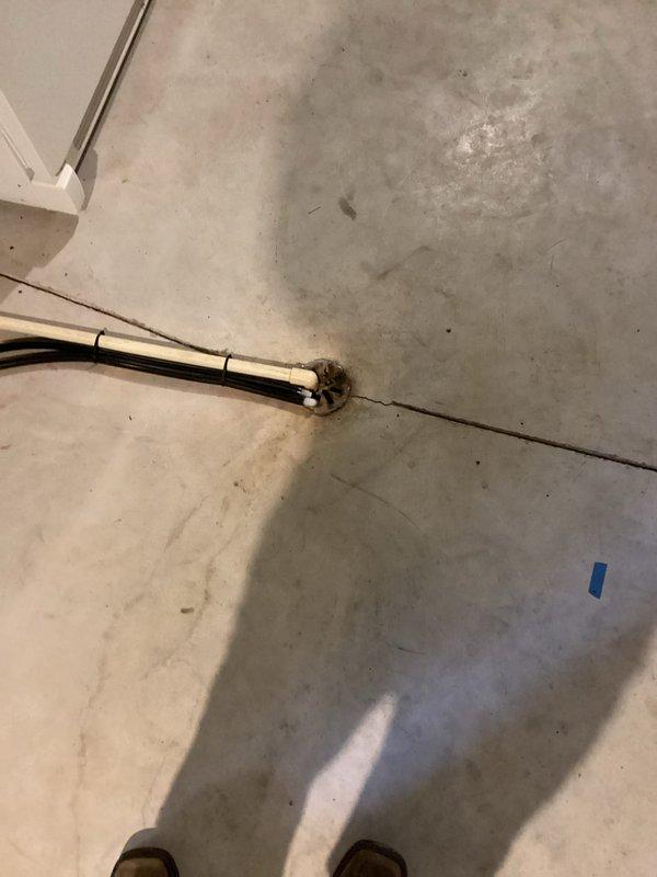 Successfully completed installation of a new residential HVAC system, including placement of the outdoor condenser unit on a level pad adjacent to the home's exterior. System installation included proper electrical connections with protective conduit and appropriate drainage setup through the concrete floor to ensure proper condensate removal.