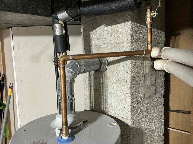 Conducted detailed assessment of existing water heater system and associated plumbing connections in utility area. Documented valve assembly condition, noting minor corrosion at connection points. Recommended replacement of aging components to prevent potential leaks and ensure optimal system performance.