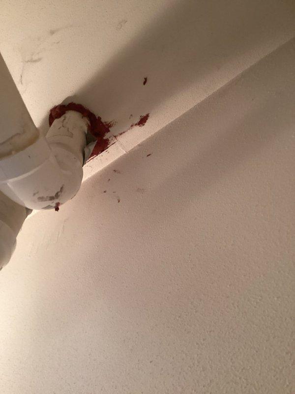 Responded to callback regarding improperly sealed condensate drain lines. Upon inspection, identified excessive red PVC cement/primer around pipe connections causing wall staining. Cleaned affected areas, resealed connections properly, and verified drainage system functionality.