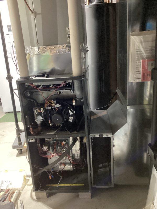 Performed comprehensive HVAC system tune-up including inspection of furnace components with full access panel removal. Conducted combustion analysis using Testo 310 analyzer, measuring efficiency parameters including temperature, O2/CO2 levels, and draft pressure. All readings within acceptable operational parameters at 82.2% efficiency.