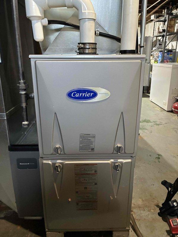 Performed seasonal tune-up on Carrier furnace. Conducted amperage test using SC680 multimeter, recording 4.4 μA current draw which falls within normal operating parameters. Inspected all electrical connections, PVC venting, and visible components - all in good working condition with no signs of wear or damage. System is operating efficiently and no repairs were needed.