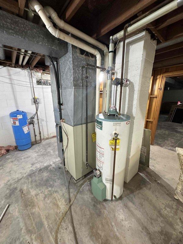 Completed comprehensive inspection of existing HVAC system in basement mechanical room, including furnace/boiler unit with extensive ductwork, water heater, and expansion tank. Documented current equipment condition showing normal wear on the aging system and evaluated ductwork insulation integrity. Prepared replacement estimate for complete system upgrade to improve efficiency and reliability.