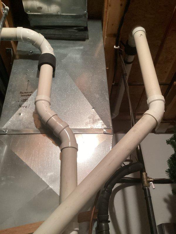 Performed standard tune-up service on residential furnace system. Inspected interior components including gas valve assembly, control module, and electrical connections - all found in normal working condition with no visible damage or abnormal wear. Examined condensate drainage system with PVC piping; verified proper installation and functionality of all ventilation components.