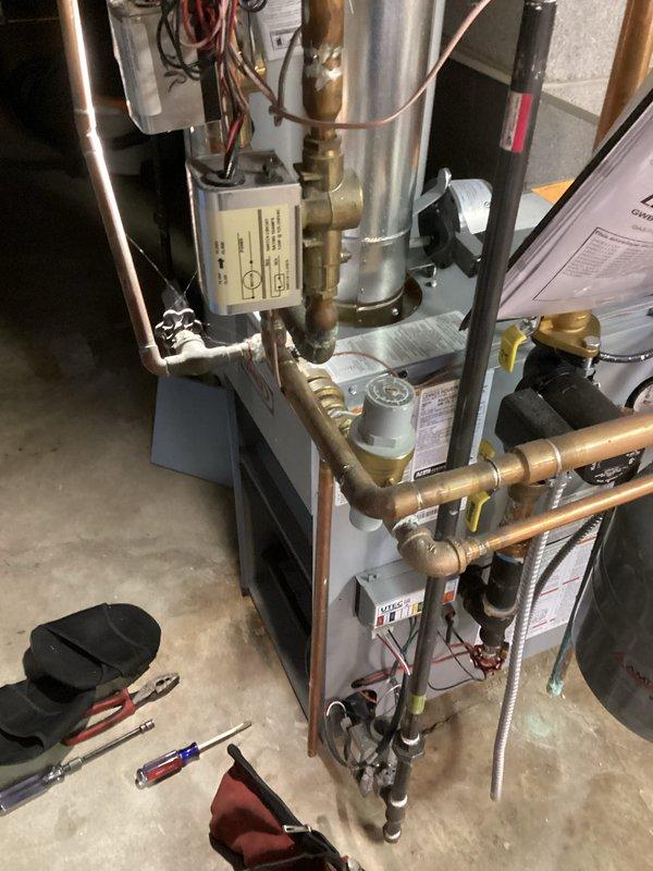 Performed routine tune-up on residential HVAC system. Inspected furnace unit, including control box, copper piping network, and electrical connections. Examined heat exchanger components for wear and discoloration, noting normal operational patterns. System operating within manufacturer specifications after service.