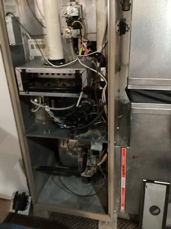 Performed comprehensive tune-up on residential HVAC system. Inspected furnace interior components including heat exchanger, electrical connections, and blower assembly - all found in satisfactory working condition. Serviced unit using standard maintenance tools and verified proper operation before closing access panel.