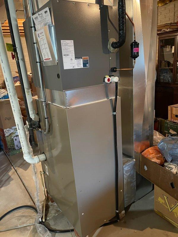 Performed routine tune-up on Carrier Comfort furnace system located in basement utility room. Inspected all components including ductwork, PVC ventilation piping, electrical connections, and air filter. System appears to be in good working condition with no visible damage or wear detected.