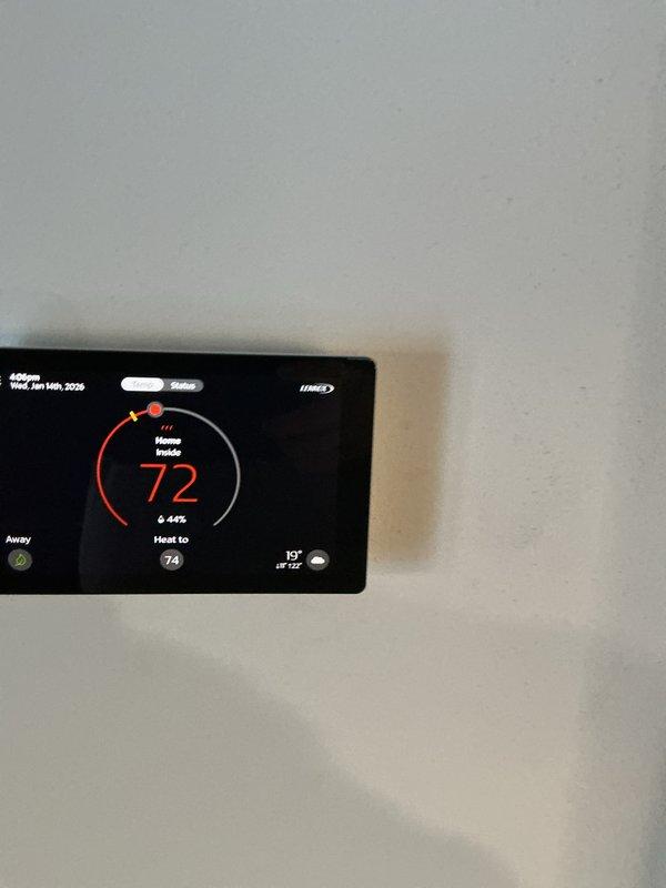 Performed inspection of heating system and thermostat operation. Verified thermostat displaying correctly with heat set point at 74°F and current indoor temperature reading 72°F. System functioning within normal parameters.