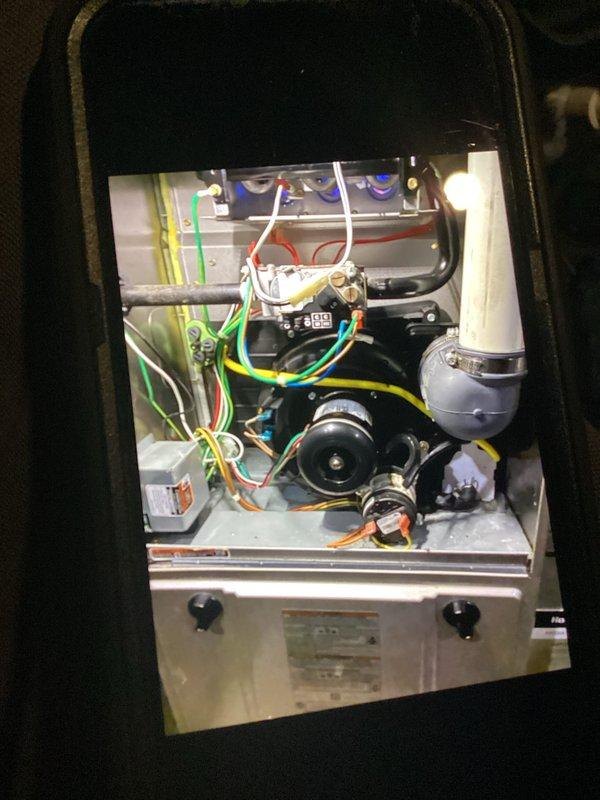 Performed comprehensive furnace inspection, focusing on blower motor assembly and electrical connections. Inspected all wiring (red, yellow, green, blue, white) for proper connections and integrity. Verified proper operation of control board components and checked ventilation/drainage system including PVC piping for obstructions.