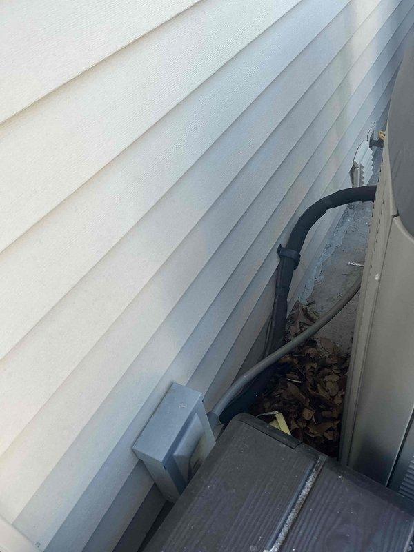 Conducted comprehensive IAQ assessment of residential HVAC system, including inspection of outdoor condensing unit installation and ductwork condition in basement/crawl space. Evaluated exterior unit placement, refrigerant line connections, and electrical components, noting proper installation on concrete pad. Examined basement ductwork insulation integrity and PVC condensate drainage system. All components appeared to be functioning within normal parameters.