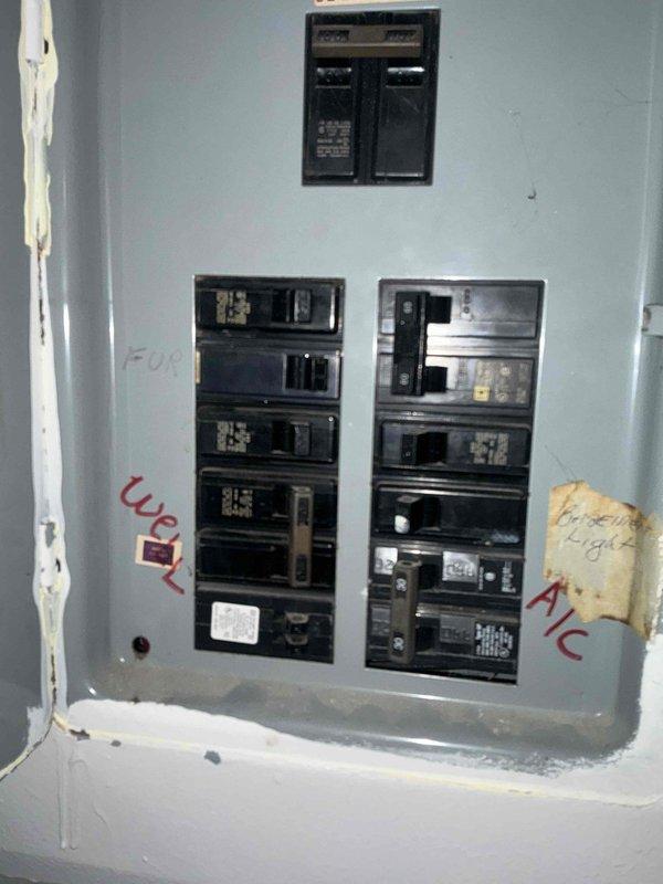 Conducted comprehensive inspection of electrical panel and HVAC system components. Identified aging breaker box with multiple circuit connections including dedicated A/C circuit. Examined mechanical area containing ductwork, PVC piping, and electrical wiring configuration. Documented current system layout to prepare for replacement unit installation.