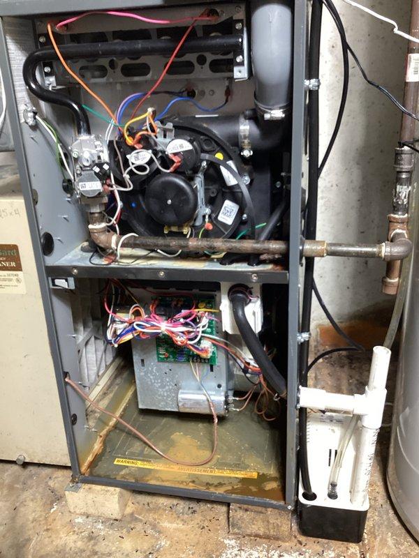 Conducted combustion analysis on natural gas furnace using Testo 310 II analyzer, confirming proper operation with 89.3% efficiency, acceptable CO levels (6 ppm), and normal O₂ readings (9.6%). Performed visual inspection of internal components including blower assembly, control board, and condensate system; all wiring connections and components appear in normal working condition.