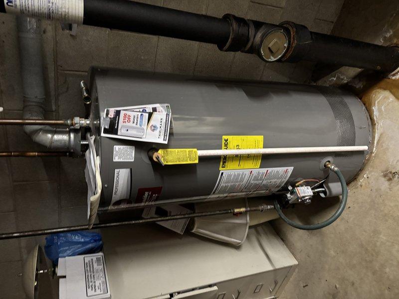 Conducted inspection of customer's water heater system and associated plumbing infrastructure. Examined copper piping connections, vent pipe installation, and operational status of control valves. Noted minor evidence of previous water leakage near valve connections, but confirmed system is currently functioning properly with no active leaks or safety concerns.