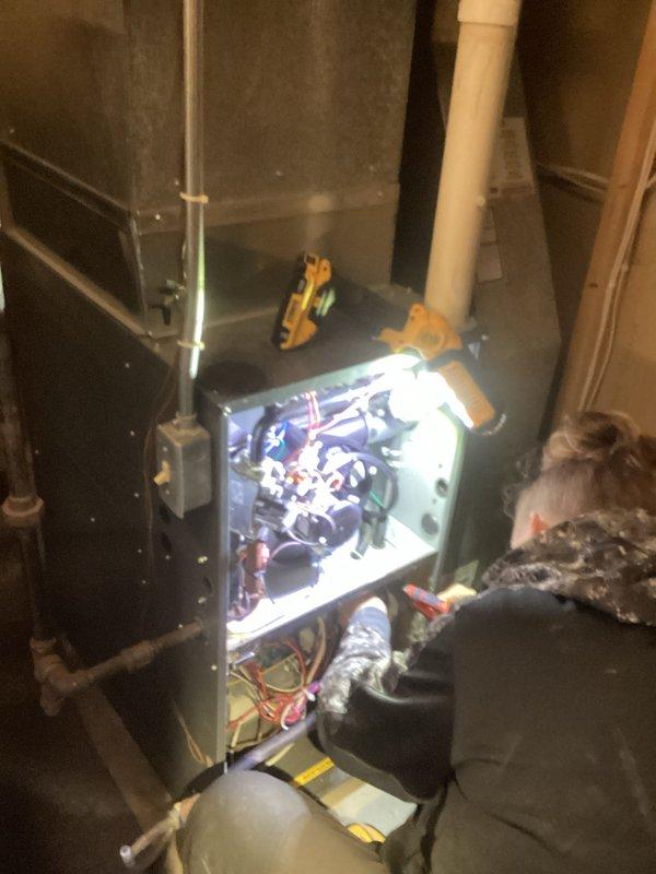 Responded to a no-heat call for an aging HVAC system (10+ years). Upon inspection, accessed the furnace control panel to diagnose electrical components and wiring connections. Performed comprehensive system evaluation, focusing on critical components visible in the utility area installation with connected PVC ventilation piping and ductwork.