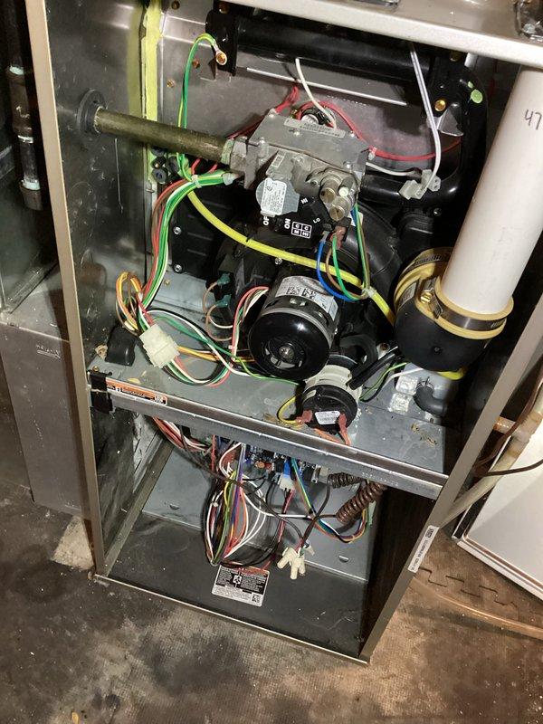Performed comprehensive tune-up on residential gas furnace including combustion efficiency testing using Testo 310 analyzer, which displayed satisfactory readings for CO2, O2, and efficiency values. Inspected interior components including gas valve assembly, blower motor, and control board connections, confirming proper wire terminations and component functionality. All systems operating within manufacturer specifications after service.