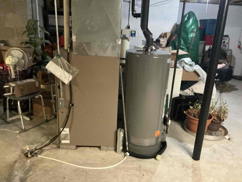 Conducted comprehensive assessment of existing HVAC system in basement utility room. Documented aging furnace unit with deteriorating components and suboptimal ductwork configuration. Provided detailed replacement estimate for upgrading to a more efficient heating system with proper ventilation requirements, including necessary modifications to existing ductwork and connections to water heater system.