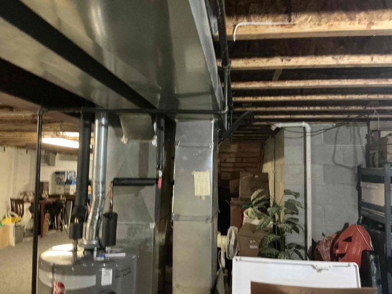 Conducted comprehensive assessment of existing HVAC system in basement utility room. Documented aging furnace unit with deteriorating components and suboptimal ductwork configuration. Provided detailed replacement estimate for upgrading to a more efficient heating system with proper ventilation requirements, including necessary modifications to existing ductwork and connections to water heater system.