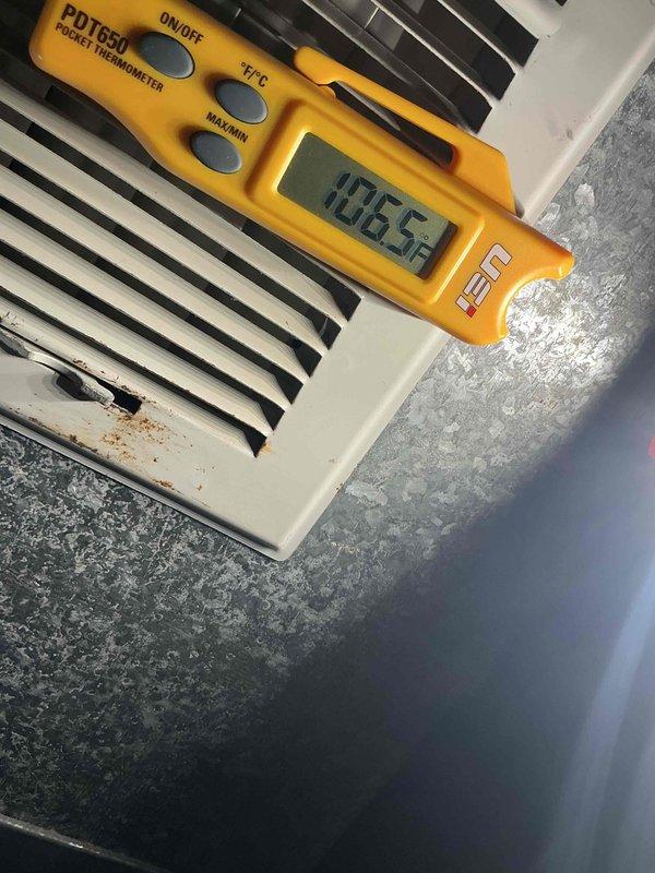 Performed scheduled maintenance on residential HVAC system. Inspected furnace unit with visible service tag and measured supply air temperature (106.5°F) using PDT650 thermometer. System operating within normal parameters with no issues detected.