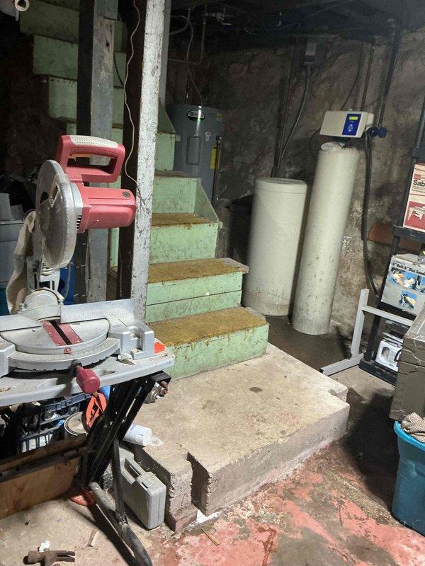 Conducted assessment of basement HVAC system for potential replacement. Identified aging equipment and potential installation challenges posed by existing plumbing configuration. Evaluated space constraints around utility area where water treatment systems are installed. Documented structural concerns including wall cracks that may require attention during new system installation.