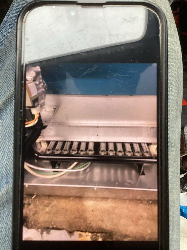 Performed routine tune-up service on HVAC system, including inspection of interior evaporator coil which showed some dirt accumulation at base requiring cleaning. Examined water heater and associated copper piping network, confirming proper installation with no leaks detected in plumbing infrastructure.