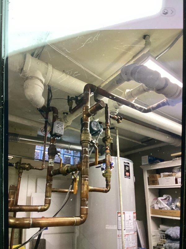 Performed routine tune-up service on HVAC system, including inspection of interior evaporator coil which showed some dirt accumulation at base requiring cleaning. Examined water heater and associated copper piping network, confirming proper installation with no leaks detected in plumbing infrastructure.