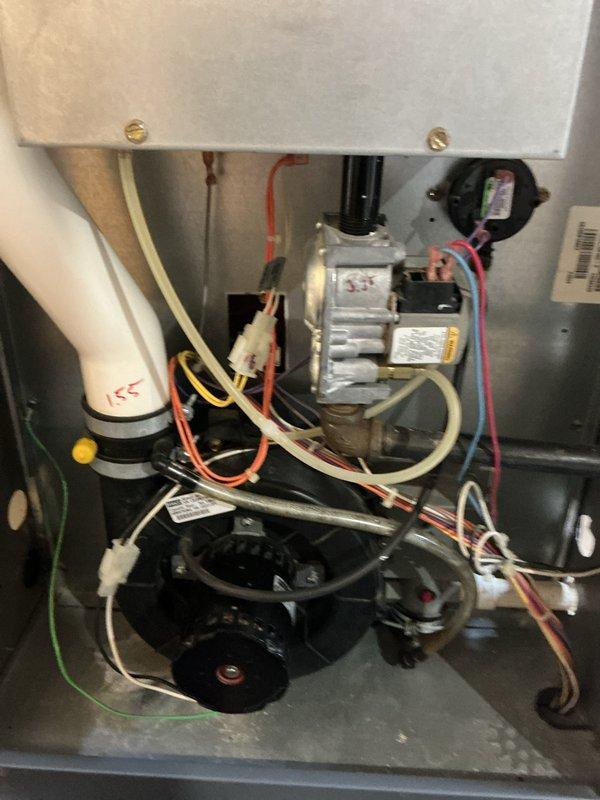 Completed comprehensive tune-up of HVAC system, inspecting both the condensate drainage assembly and furnace components. Verified proper installation and function of PVC condensate drain lines, confirming no blockages or leaks in the drainage system. Examined furnace gas valve assembly, electrical connections, and blower motor, ensuring all components were operating within specifications and showing no signs of wear or damage.