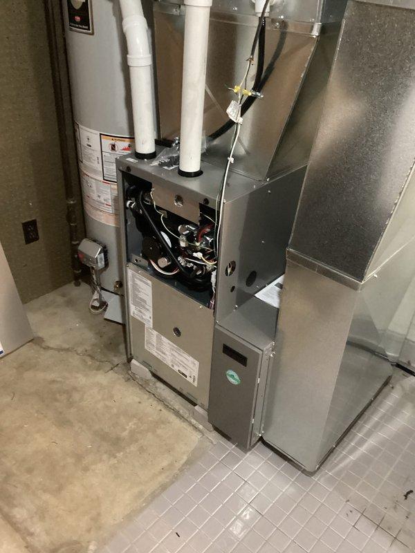 Successfully installed new furnace unit in utility room alongside existing water heater. Completed proper connection of exhaust and intake PVC venting, and ensured all ductwork connections were secure. System tested and confirmed to be in normal working condition with no leaks or issues detected.