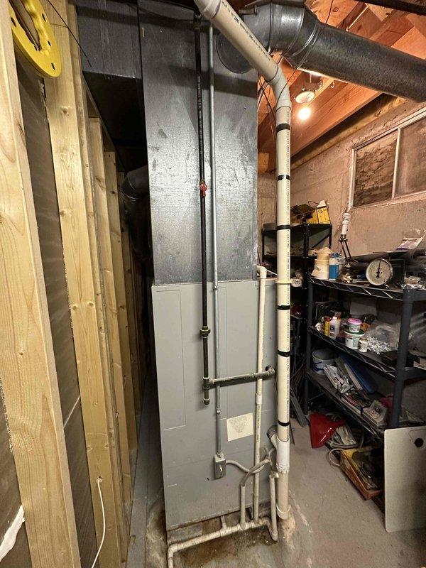 Conducted comprehensive assessment of existing HVAC system in basement utility room. Evaluated electrical panel capacity and wiring requirements for potential replacement unit. Documented current installation configuration including ductwork, PVC venting, and available utility connections to prepare accurate replacement estimate.