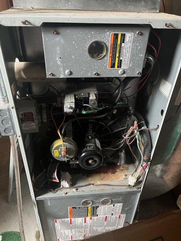 Diagnosed and serviced an aging furnace (10+ years) that was not producing heat. Inspection revealed significant dust accumulation throughout the system with particular concentration on the blower motor assembly and circuit board. Cleaned critical components, replaced worn electrical connections, and performed system reset which restored proper heating function. Unit is operational but showing signs of age-related wear that may require more extensive service in the near future.