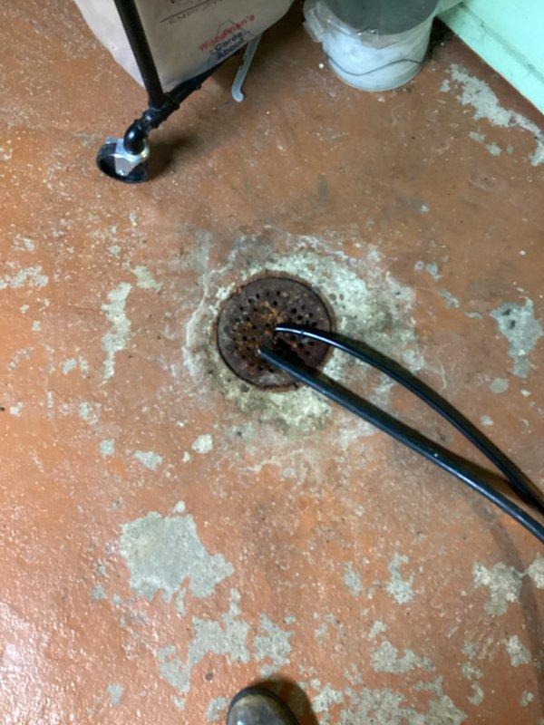 Completed installation of new HVAC system with high-efficiency furnace in basement utility area. System includes properly sealed metallic ductwork with multiple distribution branches. Noted existing floor drain shows significant corrosion; recommended monitoring for proper drainage to prevent potential water damage to new equipment.