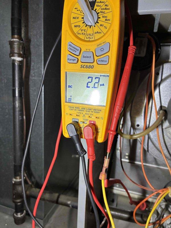 Performed comprehensive HVAC tune-up including electrical system diagnostics using multimeter (SC680) to verify proper current readings of 2.3 μA DC. Inspected Aire-Flo furnace unit and associated ductwork for proper installation and operation, confirming all components are functioning within manufacturer specifications with no visible issues detected.
