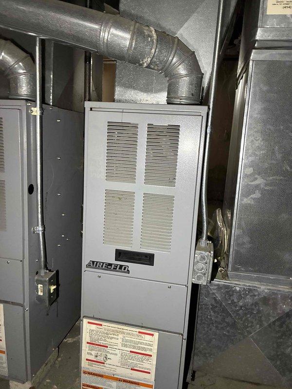 Performed comprehensive HVAC tune-up including electrical system diagnostics using multimeter (SC680) to verify proper current readings of 2.3 μA DC. Inspected Aire-Flo furnace unit and associated ductwork for proper installation and operation, confirming all components are functioning within manufacturer specifications with no visible issues detected.