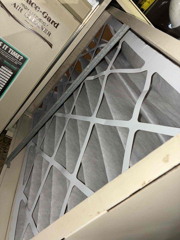 Performed routine HVAC tune-up service including inspection and evaluation of the Space-Gard air cleaner system. Examined the existing air filter which showed significant dust accumulation and possible mold growth in surrounding area. Replaced the dirty pleated filter with a new one to ensure proper system airflow and improved indoor air quality.