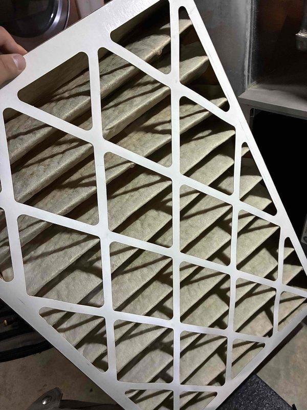 Performed scheduled maintenance on HVAC system. Conducted electrical diagnostics using Fieldpiece SC680 multimeter, verifying system voltage readings at 1.4V. Removed and replaced heavily soiled air filter showing significant dust accumulation.