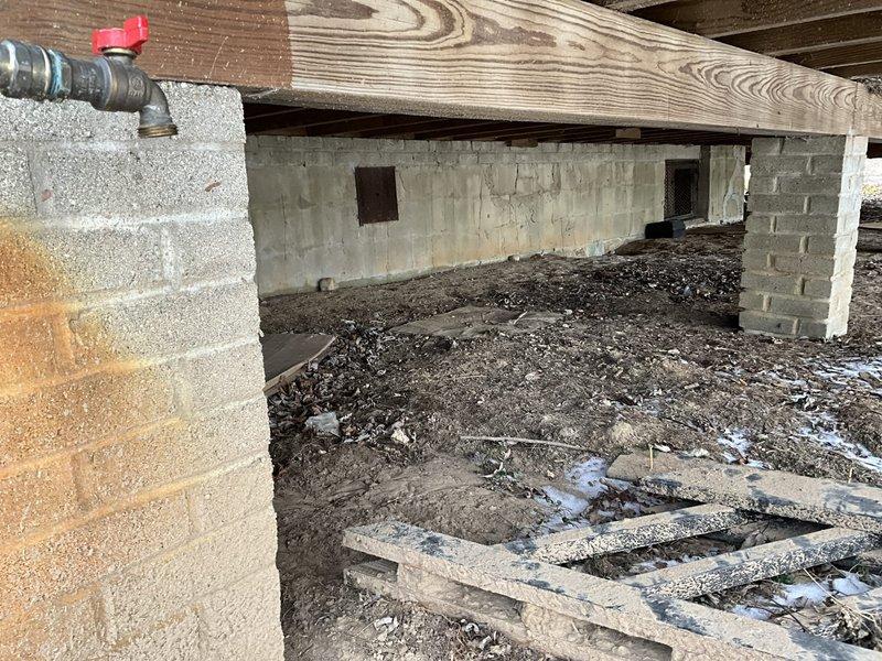 Conducted site assessment for mini-split installation, evaluating crawlspace conditions and exterior mounting options. Noted moisture issues in the crawlspace that require remediation prior to installation. Exterior wall assessment complete with measurements taken for optimal condenser placement on snow-prone deck area.