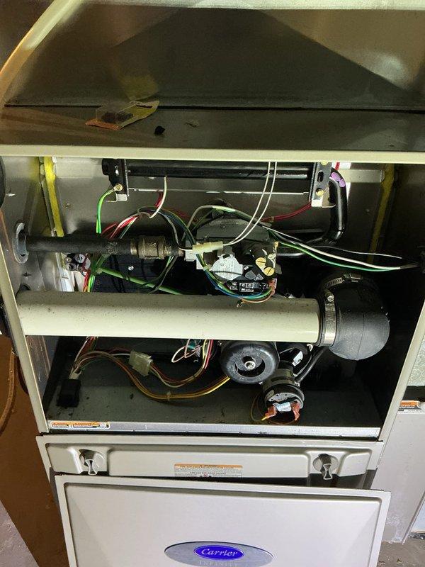 Performed routine maintenance on Carrier furnace system. Inspected interior components including blower motor, circuit board with wiring connections, and heat exchanger - all found in normal operating condition. Visual inspection showed no signs of damage or unusual wear to any components.