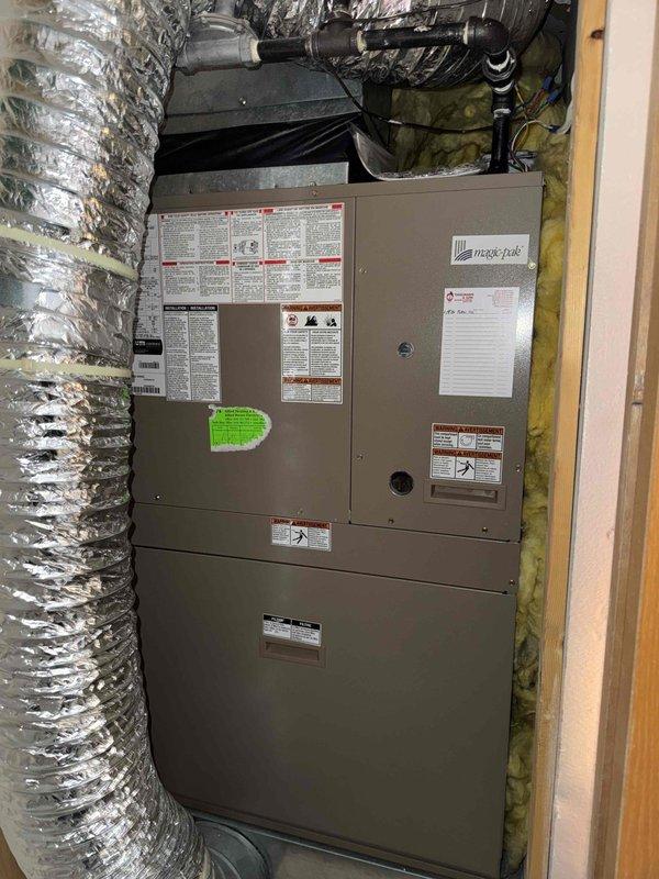 Performed routine maintenance tune-up on residential furnace system. Inspected heat exchanger and coils, noting normal copper oxidation on serpentine coils within acceptable parameters. Examined ductwork connections and verified proper insulation around unit; all components functioning correctly with no immediate service concerns identified.