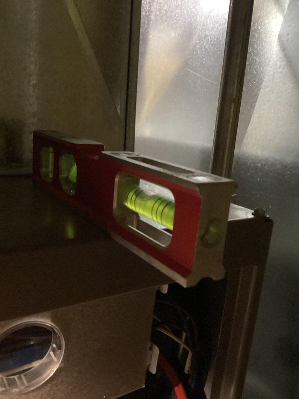 Performed routine maintenance inspection on HVAC system. Checked unit leveling using spirit level and inspected interior components including blower motor, electrical connections, and control board. All components functioning properly with no issues identified.