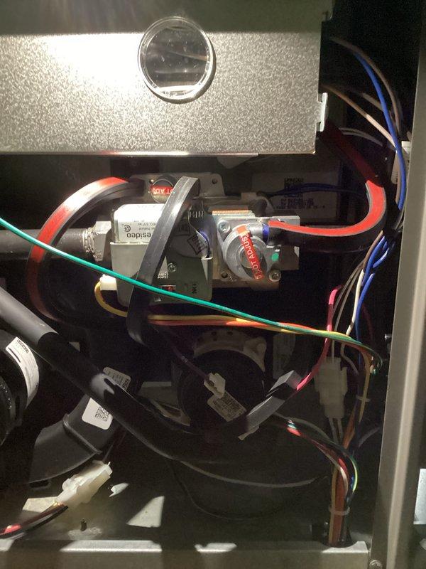 Performed routine maintenance inspection on HVAC system. Checked unit leveling using spirit level and inspected interior components including blower motor, electrical connections, and control board. All components functioning properly with no issues identified.