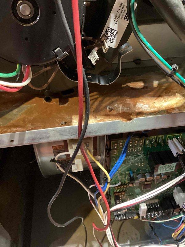 Performed routine tune-up on aging HVAC system, documenting significant rust/corrosion on internal metal components near the control board. Identified potential moisture exposure affecting the main circuit board with visible damage to surrounding wiring connections. Recommend system evaluation for possible replacement due to advanced corrosion that may compromise electrical integrity and system reliability.