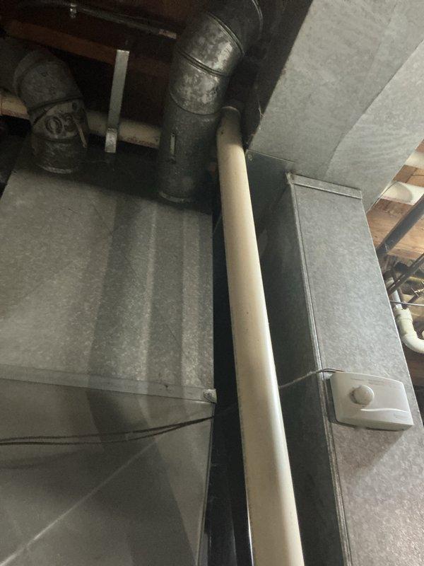 Performed routine tune-up service on HVAC system, inspecting blower wheel assembly and associated electrical components which showed normal wear but remain in functional condition. Examined ductwork and drainage system in utility area, confirming proper installation of galvanized sheet metal ducts and PVC drainage pipe with no visible issues detected.