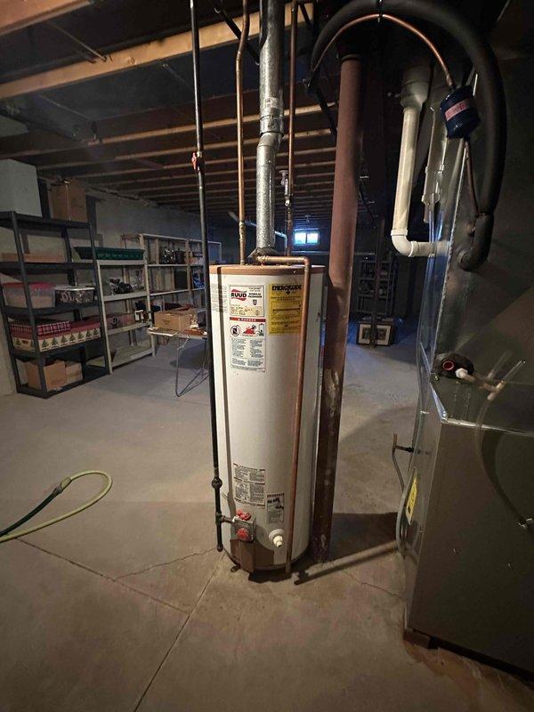 Conducted inspection of existing water heater system in unfinished basement showing signs of rust and deterioration. Provided estimate for complete replacement of aging unit, including new connections to existing copper supply lines and proper venting. Recommended upgrading to more efficient model based on household needs and current mechanical room configuration.