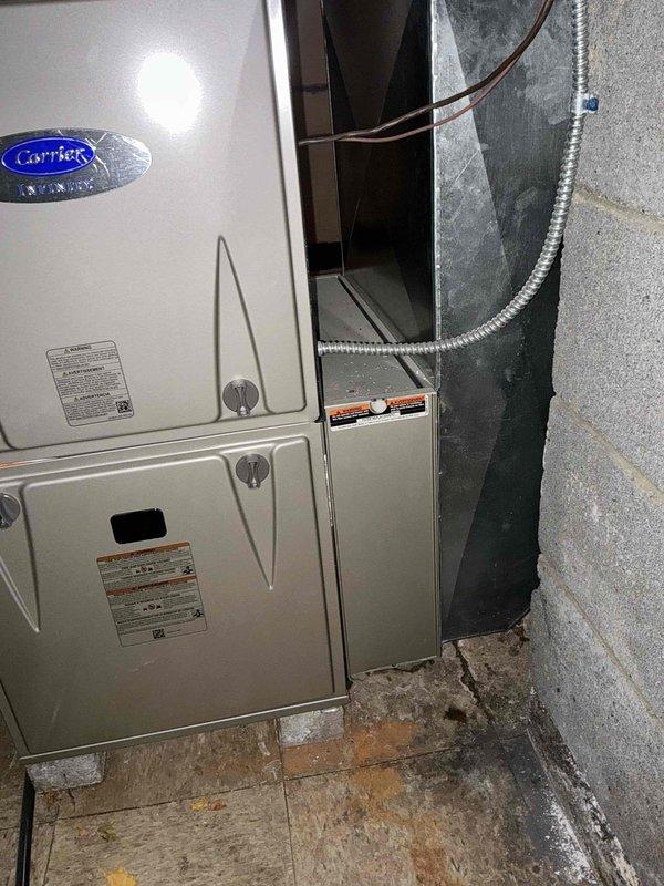 Performed comprehensive inspection of Carrier HVAC system located in utility area. Evaluation included examination of ductwork connections, with particular attention to the silver metallic flexible ducts and PVC pipe configuration. Recommended thorough cleaning of all accessible ductwork to improve system efficiency and indoor air quality.