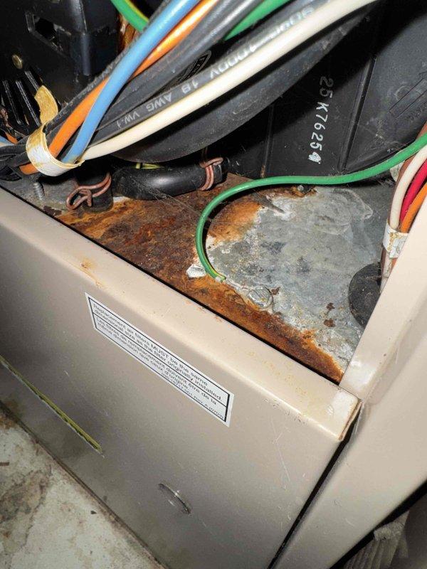 Responded to no-heat call for aging system (10+ years). Inspection revealed significant corrosion and rust damage to control board housing and electrical components. Moisture intrusion evident throughout unit with water stains on interior surfaces. Replaced corroded control board and associated wiring to restore heating functionality.