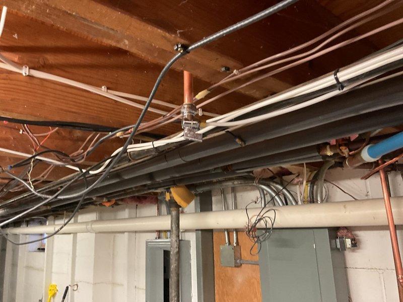 Conducted comprehensive inspection of residential water service system in unfinished basement. Examined copper water supply lines, PEX tubing connections, and existing pipe fittings for potential upgrade opportunities. Documented current configuration of plumbing infrastructure to prepare detailed estimate for water service replacement or modification.