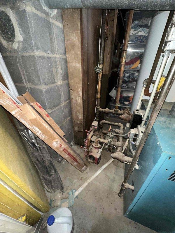 Conducted a comprehensive assessment of the existing utility area with focus on plumbing and mechanical systems. Documented the condition of copper piping, valves, and fittings in the wall cavity, noting signs of aging and discoloration. Evaluated the adjacent mechanical equipment for potential HVAC system replacement, with particular attention to integration with existing plumbing infrastructure.